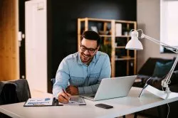 smiling man working at a desk