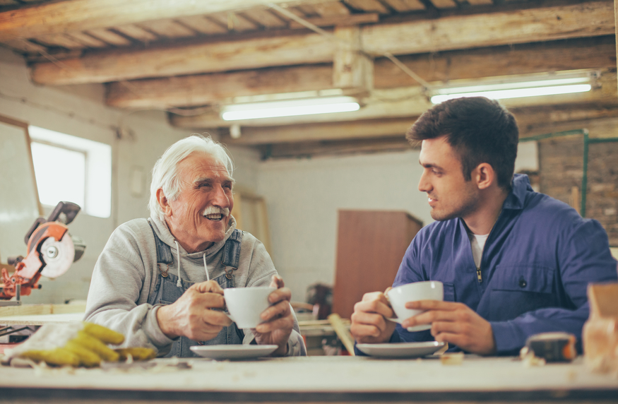 old and young man drinking coffee and talking