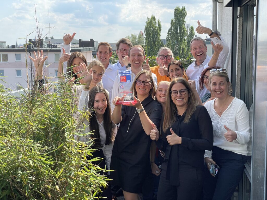 office team celebrating on a balcony on a sunny day