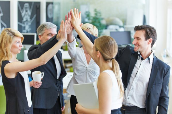 a group of business employees high fiving