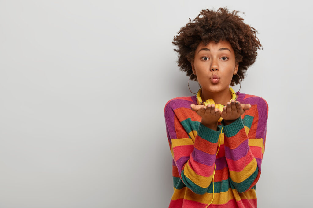 beautiful african american woman blowing a kiss