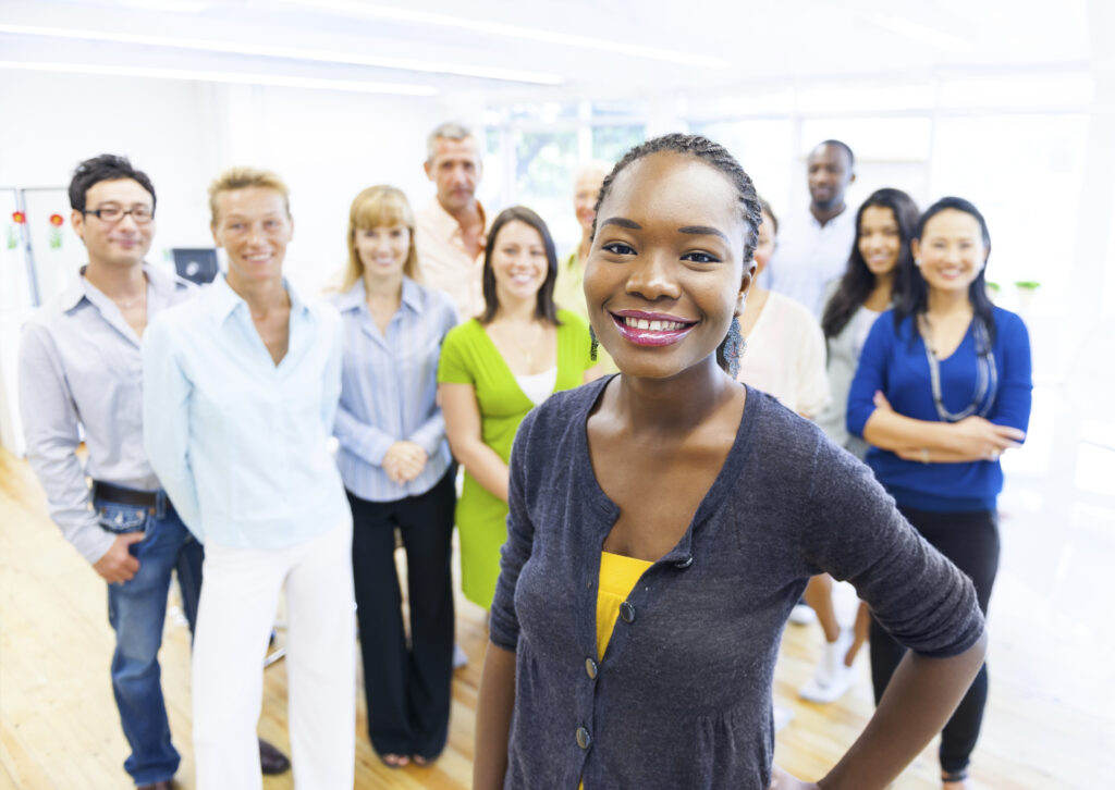 Beautiful young african american woman with colleagues in the background